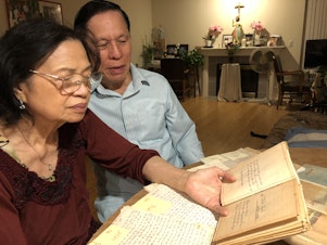 caption: Thanh Ta (right) was a prisoner in a Communist re-education camp after the Vietnam War. As a way to connect with his family thousands of miles away, he wrote letters, poems and stories. When he immigrated to the United States, he kept every single piece of writing. He reads over them with his wife, Nu, over 40 years after they were written. 