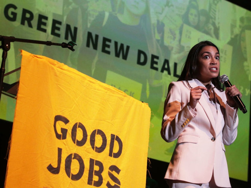 caption: Rep. Alexandria Ocasio-Cortez, D-N.Y., speaks during a rally at Howard University on Monday. The Sunrise Movement held an event for the final stop of the "Road to a Green New Deal" tour to "explore what the pain of the climate crisis looks like in D.C. and for the country and what the promise of the Green New Deal means."