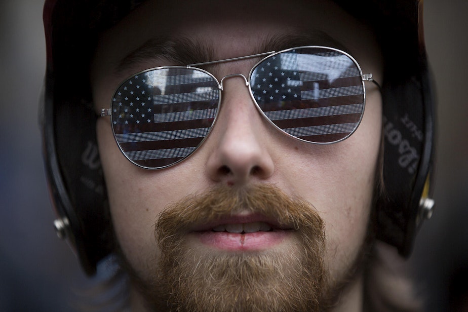 caption: Josh Potter of Vancouver, Wash. attends a pro-Trump rally at Westlake Plaza in downtown Seattle on Monday, May 1, 2017.