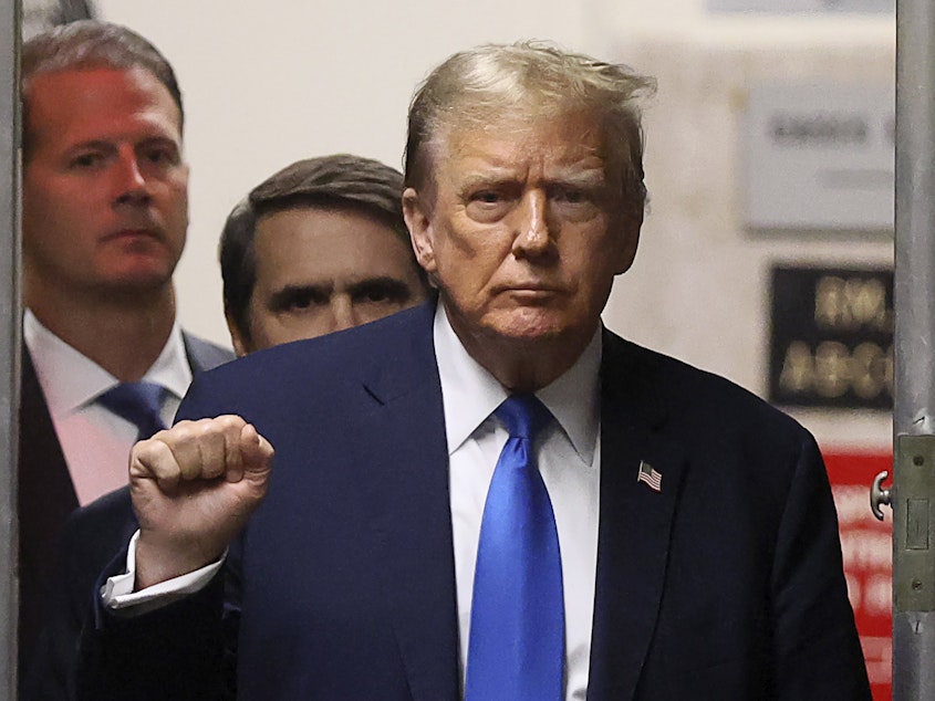 caption: Former President Donald Trump gestures as he returns to the courtroom during a recess in his criminal trial at Manhattan Criminal Court on Thursday.