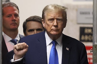 caption: Former President Donald Trump gestures as he returns to the courtroom during a recess in his criminal trial at Manhattan Criminal Court on Thursday.