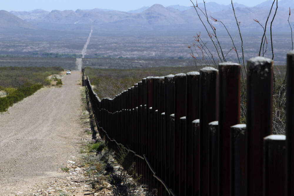caption: A U.S. Customs and Border Patrol truck, in the distance, patrols the U.S. border with Mexico, March 18, 2016, in Douglas, Ariz. (Ricardo Arduengo/AP)