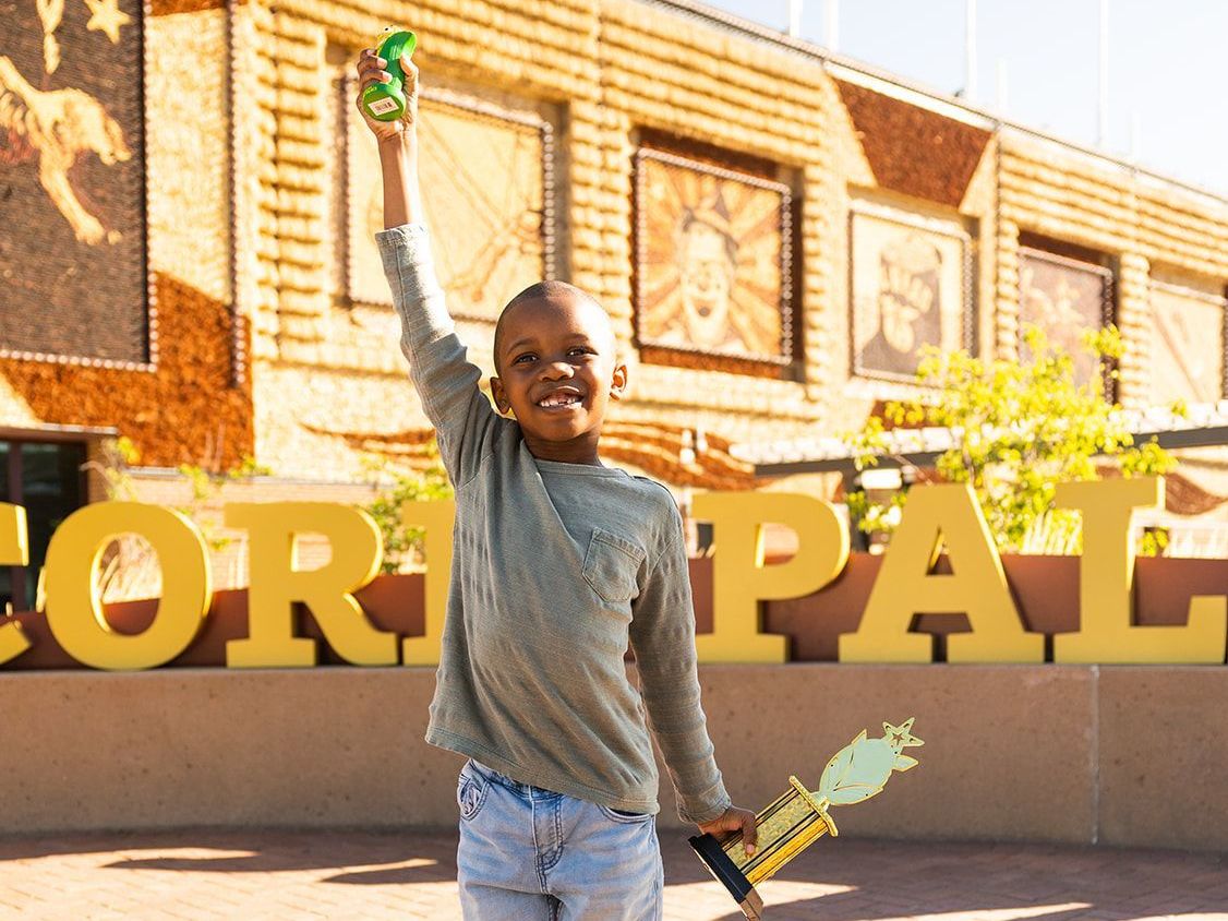 caption: Tariq and his family traveled from New York to South Dakota's corn palace for a ceremony honoring his new position as the state's official corn-bassador.