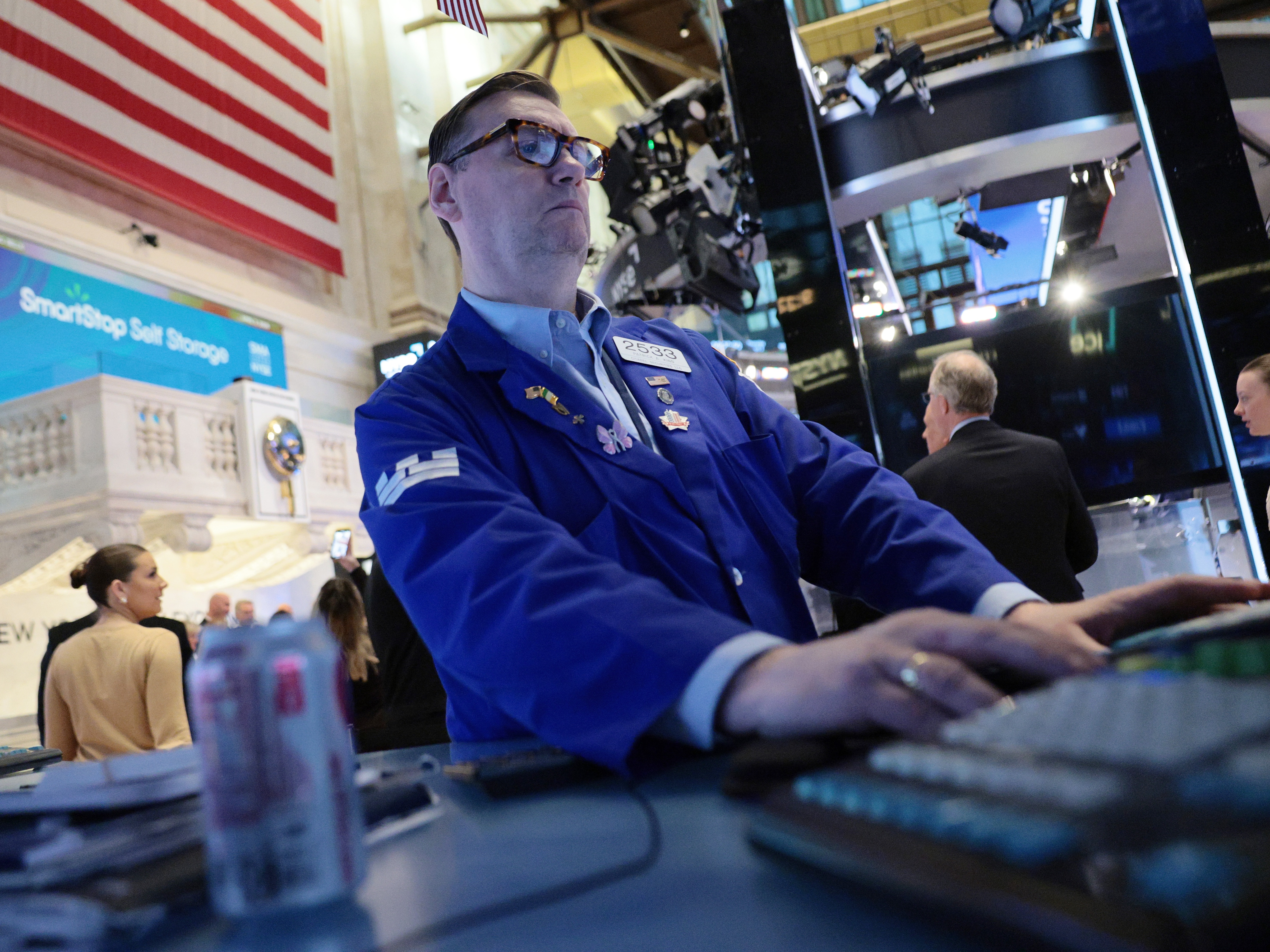caption: Traders work on the floor of the New York Stock Exchange during morning trading on April 2, 2026 in New York City.