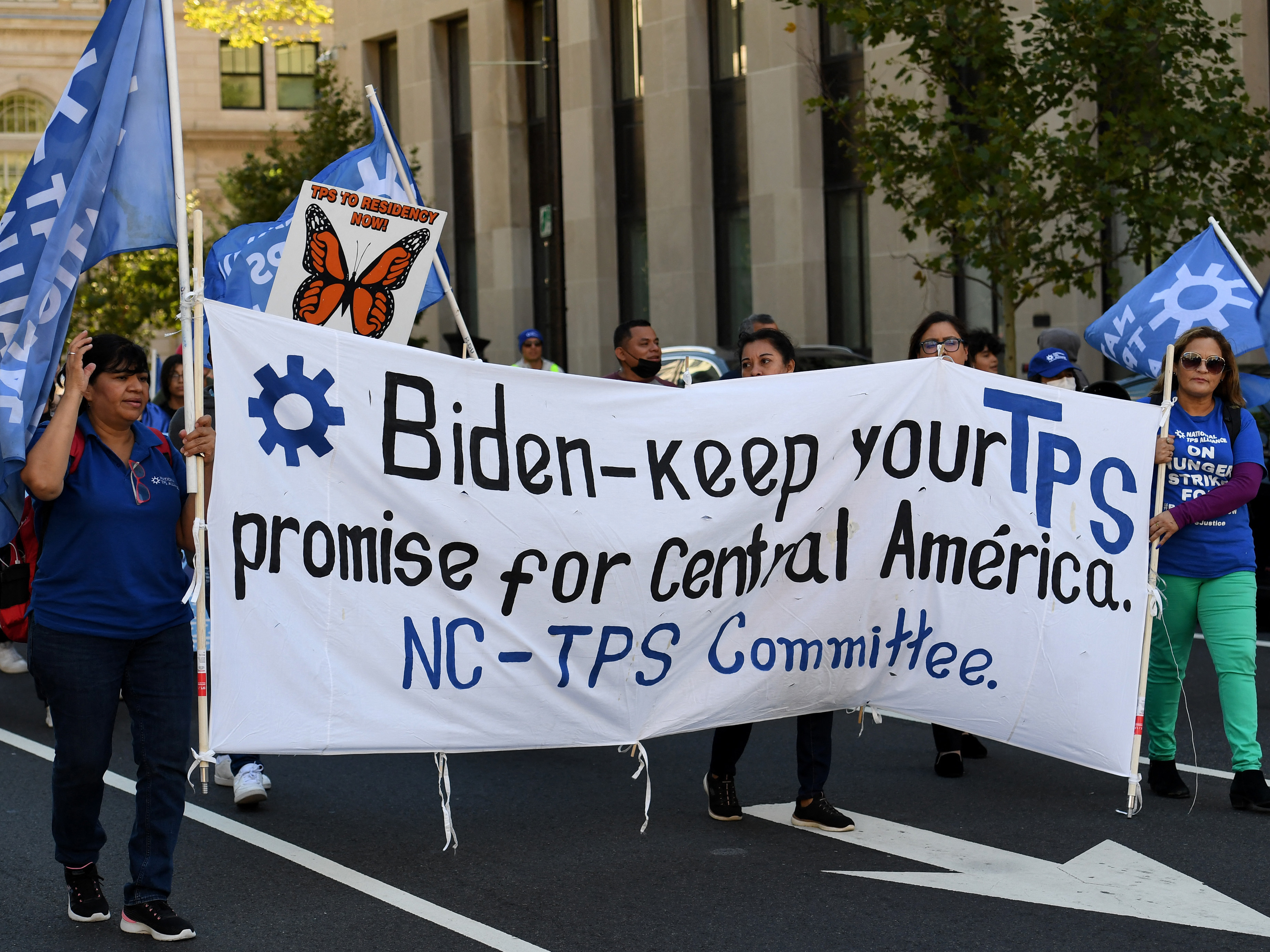 caption: Activists and citizens with Temporary Protected Status (TPS) march near the White House for residency protections in Washington D.C. in September.