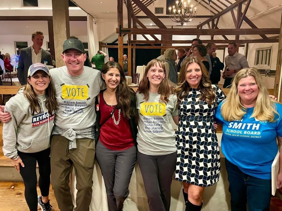 caption: Five Democratic Central Bucks School District candidates pose with current school board member Mariam Mahmud at the Bucks County Democratic headquarters on election night. Pictured left to right: Heather Reynolds, Rick Haring, Mahmud, Susan Gibson, Dana Foley and Karen Smith.
