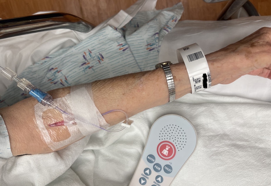 caption: A patient suffering from heat exhaustion and dehydration receives an intravenous drip of saline solution in the emergency room of UW Medical Center – Northwest in Seattle on July 27. The name on her wristband has been digitally obscured. 