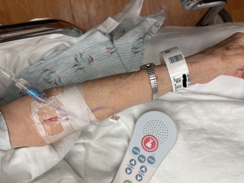 caption: A patient suffering from heat exhaustion and dehydration receives an intravenous drip of saline solution in the emergency room of UW Medical Center – Northwest in Seattle on July 27. The name on her wristband has been digitally obscured. 
