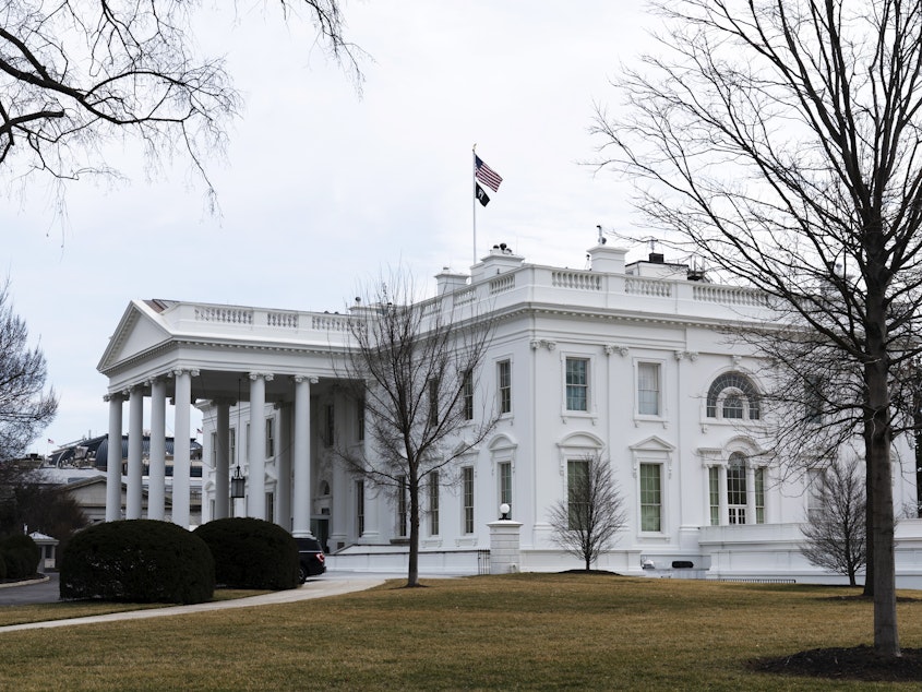 caption: An American flag flies on top of the White House, Feb. 12, 2022, in Washington. A federal appeals court Friday, Sept. 8, 2023, significantly whittled down a lower court's order curbing Biden administration communications with social media companies over controversial content about COVID-19 and other issues.
