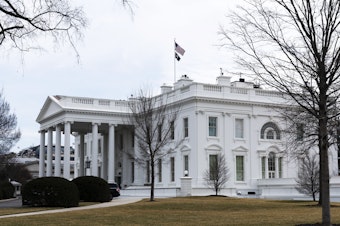 caption: An American flag flies on top of the White House, Feb. 12, 2022, in Washington. A federal appeals court Friday, Sept. 8, 2023, significantly whittled down a lower court's order curbing Biden administration communications with social media companies over controversial content about COVID-19 and other issues.