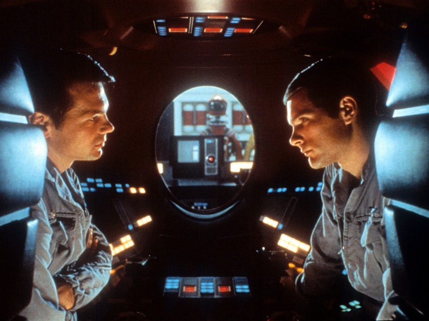 caption: Malevolent robot stories used to be more about brawn than brain — so it was a genuine shock for audiences in 1968 when the sentient HAL-9000 computer calmly said, "I'm sorry, Dave, I'm afraid I can't do that." Above, Gary Lockwood and Keir Dullea in <em>2001: A Space Odyssey</em>.