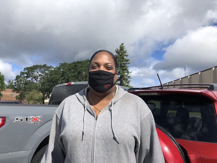 caption: Military veteran January Adams relies on her disability check to pay for rent, utilities, and other bills. Sometimes there's not enough left for food. Adams came to a recent food distribution event specifically for military families.  