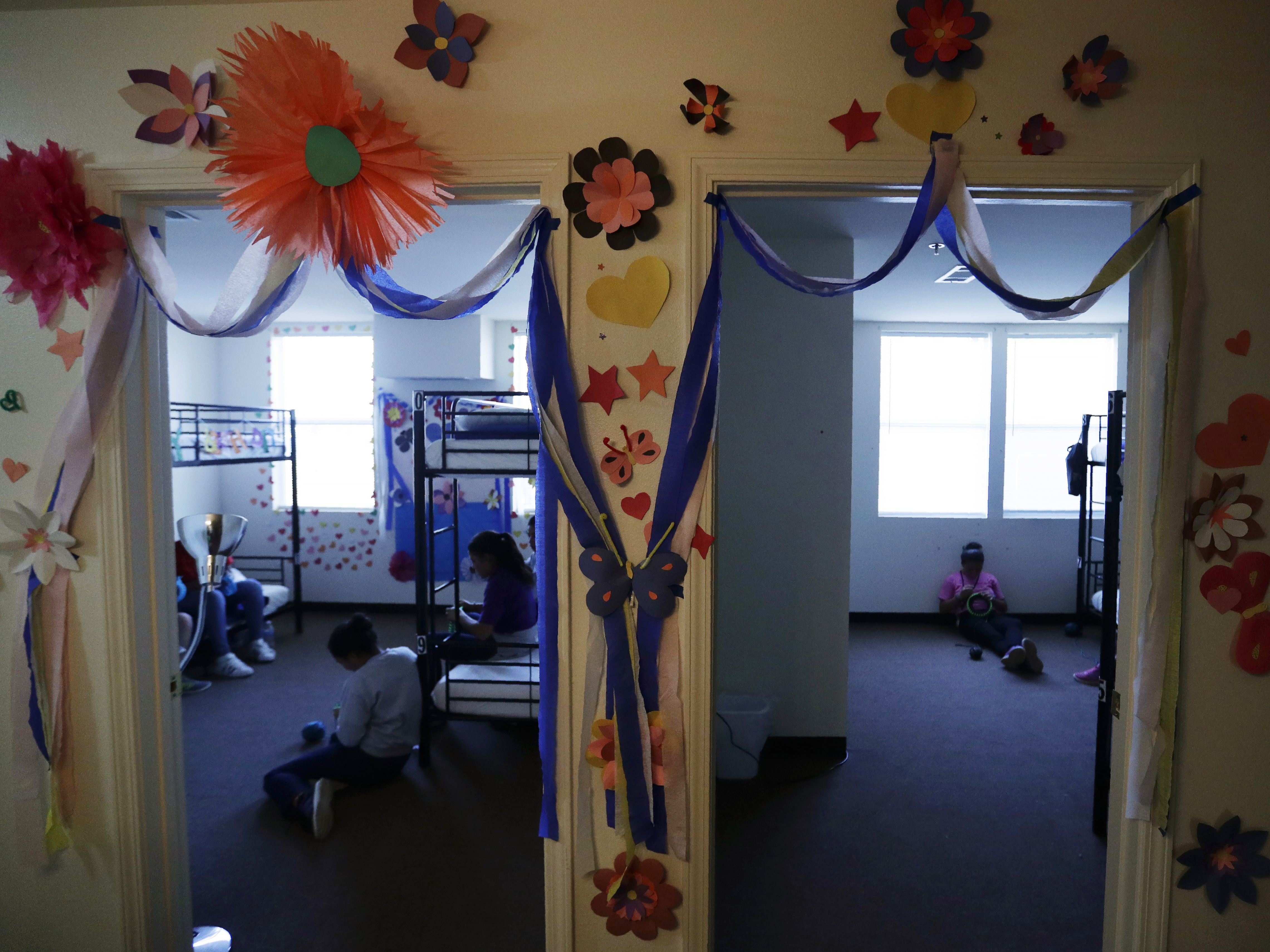 caption: The Biden administration has reopened shelters for migrant teens that were first used by the Trump administration in Carrizo Springs, Texas. Long trailers that previously housed oil workers in two-bedroom suites were turned into dorms with bunk beds, classrooms and medical care.