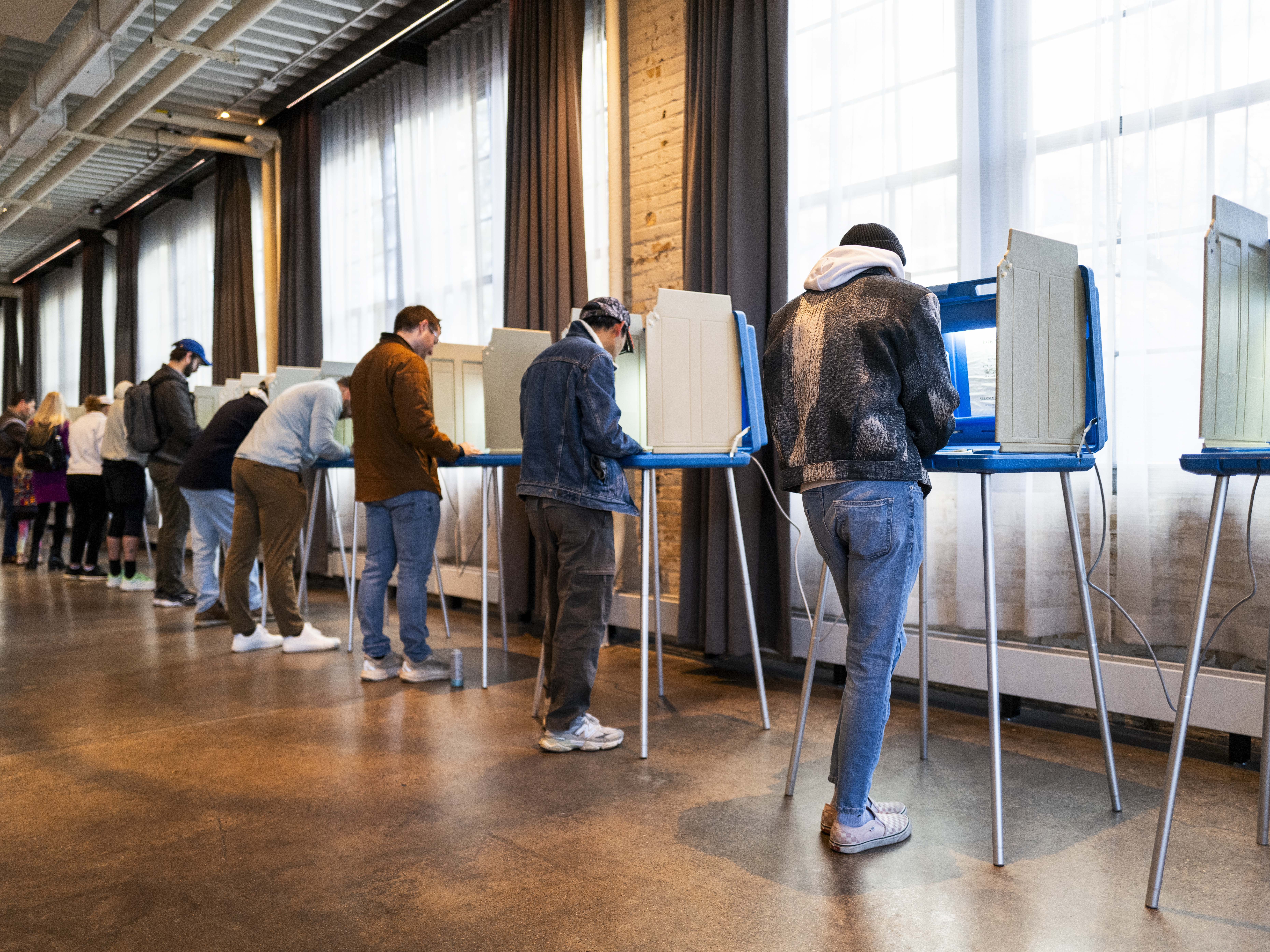 caption: Voters fill out their ballots at a polling place on Election Day, Nov. 4, in Minneapolis, Minn.