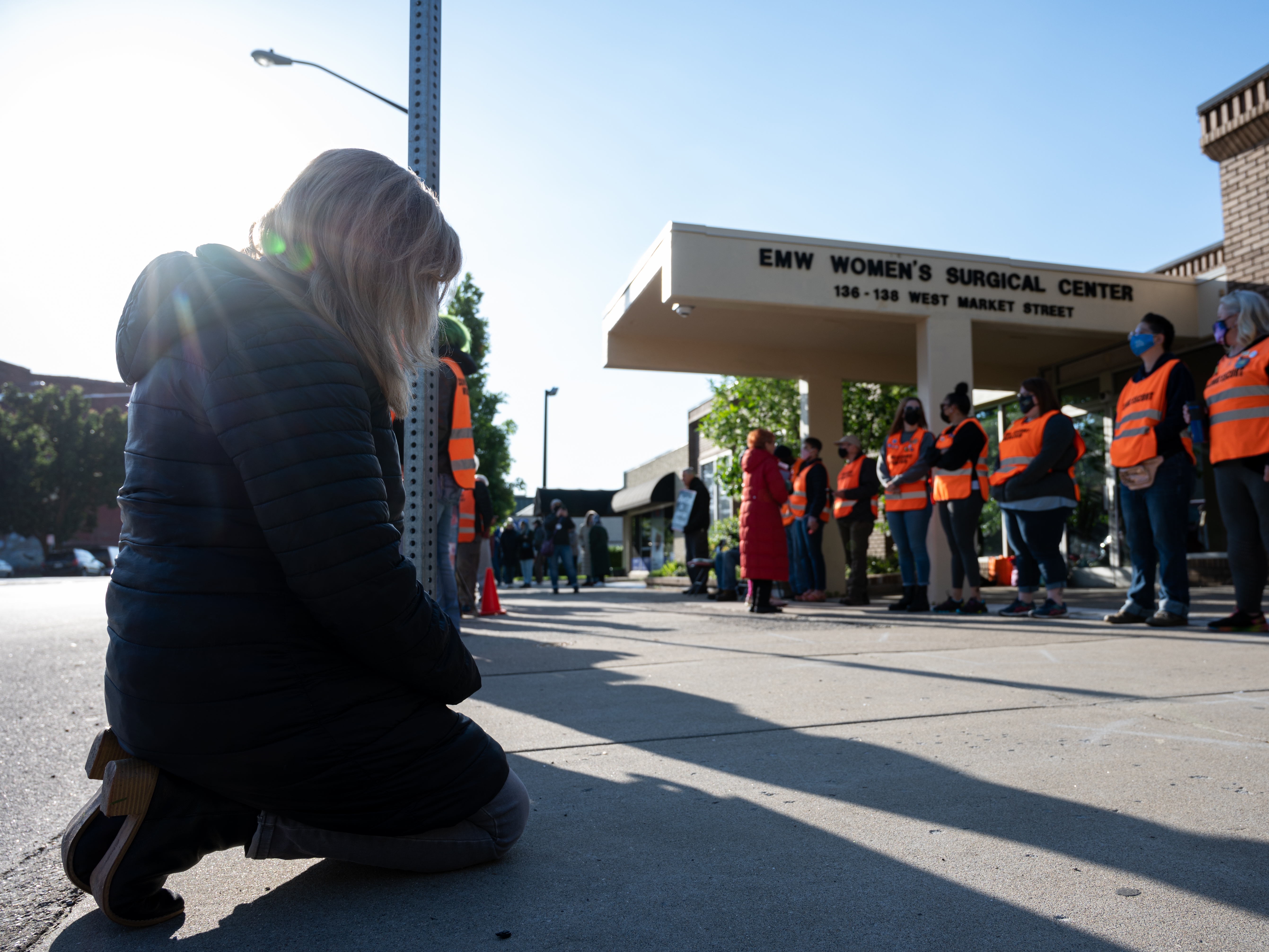 caption: Abortion-rights advocates think the Trump administration's limits on enforcing the FACE Act give a green light to anyone who wants to disrupt abortion centers in the future. Here, an anti-abortion demonstrator is shown before a line of volunteer clinic escorts in front of the EMW Women's Surgical Center, an abortion clinic, in 2021 in Louisville, Kentucky.