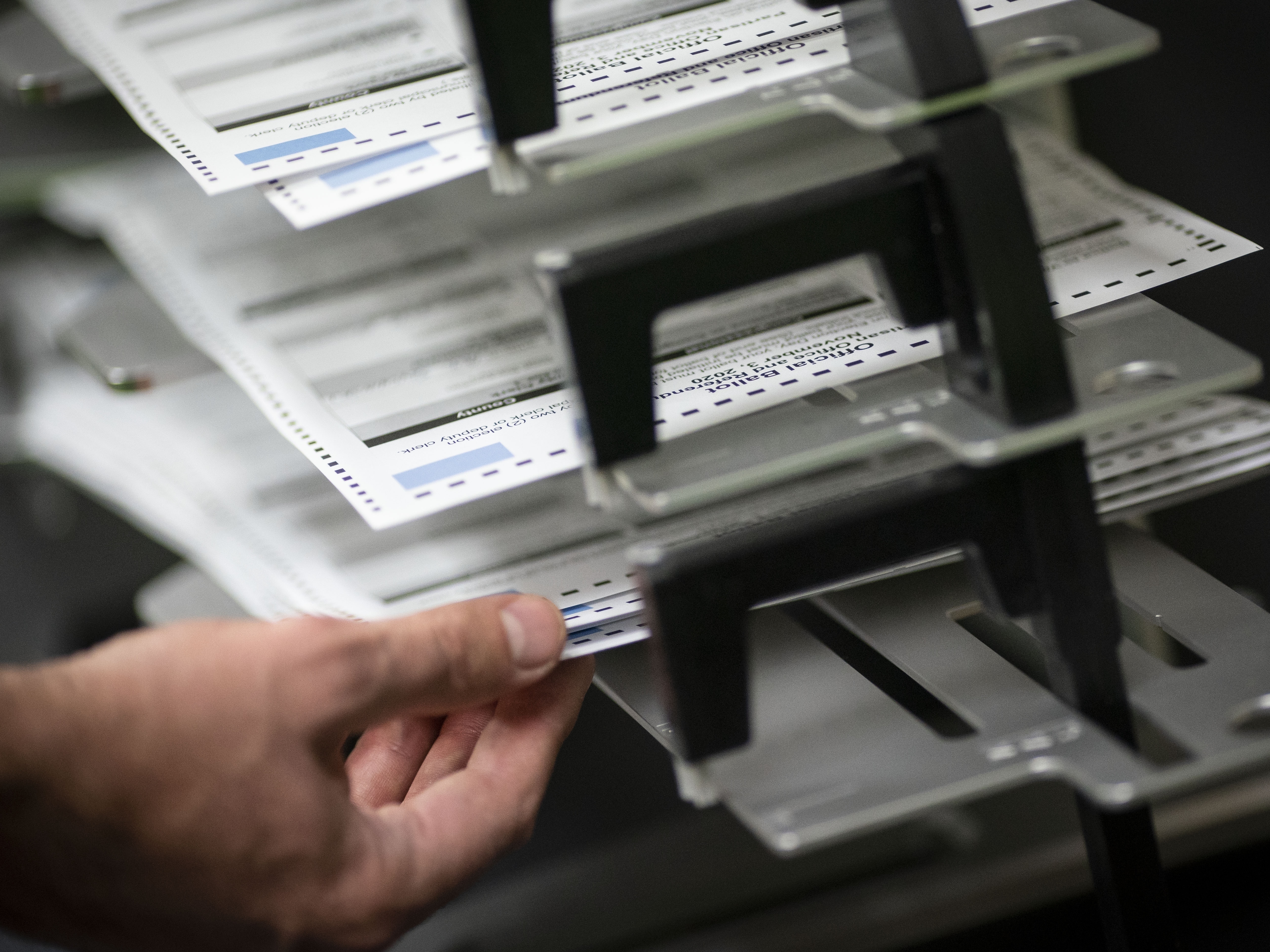 caption: Poll workers sort out early and absentee ballots on Election Day in Kenosha, Wis. Hours after the polls closed around the country, there's still no winner in the presidential contest.