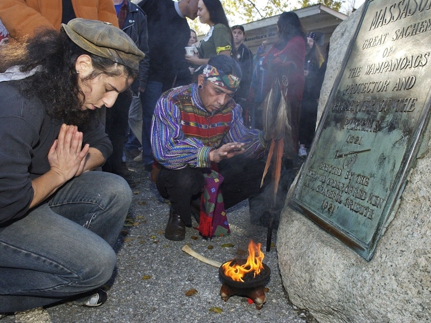 caption: Supporters of Native Americans pause following a prayer during the 38th National Day of Mourning at Coles Hill in Plymouth, Mass., on Nov. 22, 2007. Denouncing centuries of racism and mistreatment of Indigenous people, members of Native American tribes from around New England will gather on Thanksgiving 2021 for a solemn National Day of Mourning observance.