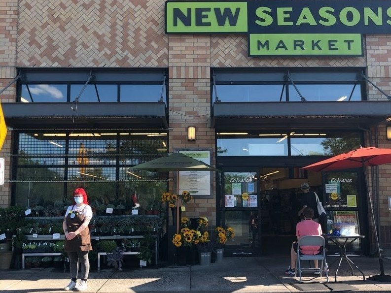 caption: Tekiah Elzey is using Coworker.org to petition for hazard pay to be restored at the New Seasons Market where she works in Portland, Ore.