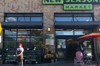 caption: Tekiah Elzey is using Coworker.org to petition for hazard pay to be restored at the New Seasons Market where she works in Portland, Ore.