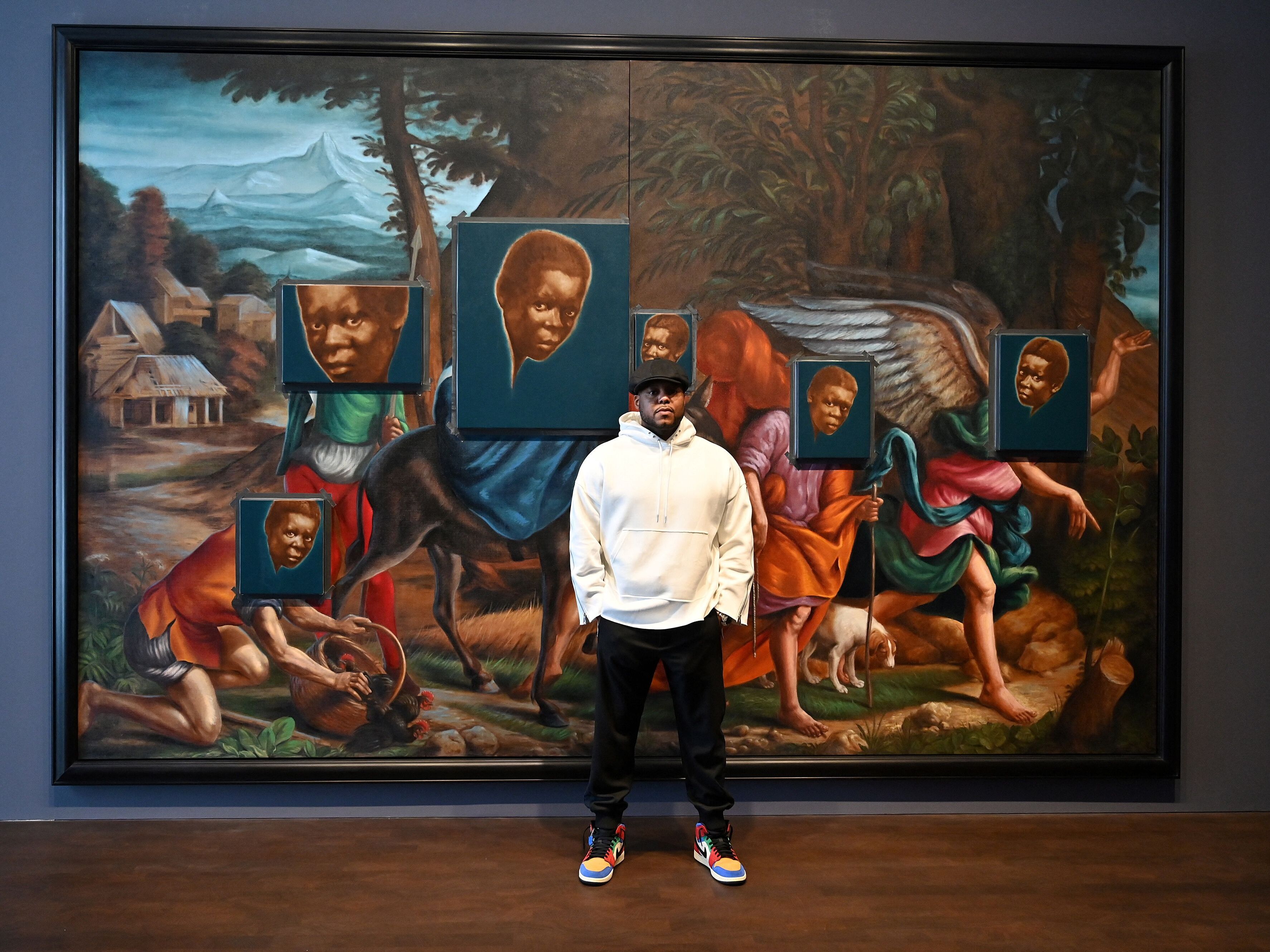caption: Artist Titus Kaphar has a new film out called<em> Exhibiting Forgiveness. </em>He's shown above with his artwork <em>From Whence I Came, </em>ahead of his 2022 exhibition at the Gagosian, Grosvenor Hill gallery in London.