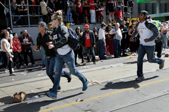 caption: Crowds scatter after reports of shots fired in Nathan Phillips Square in Toronto in June. Tens of thousands of people were gathered in the area to celebrate the Toronto Raptors' victory parade. By the end of 2019, more than 760 people had been shot in the city, 44 of whom were killed, according to Toronto Police.
