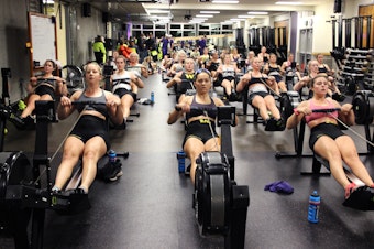 caption: UW Women's crew during an early morning work out. 