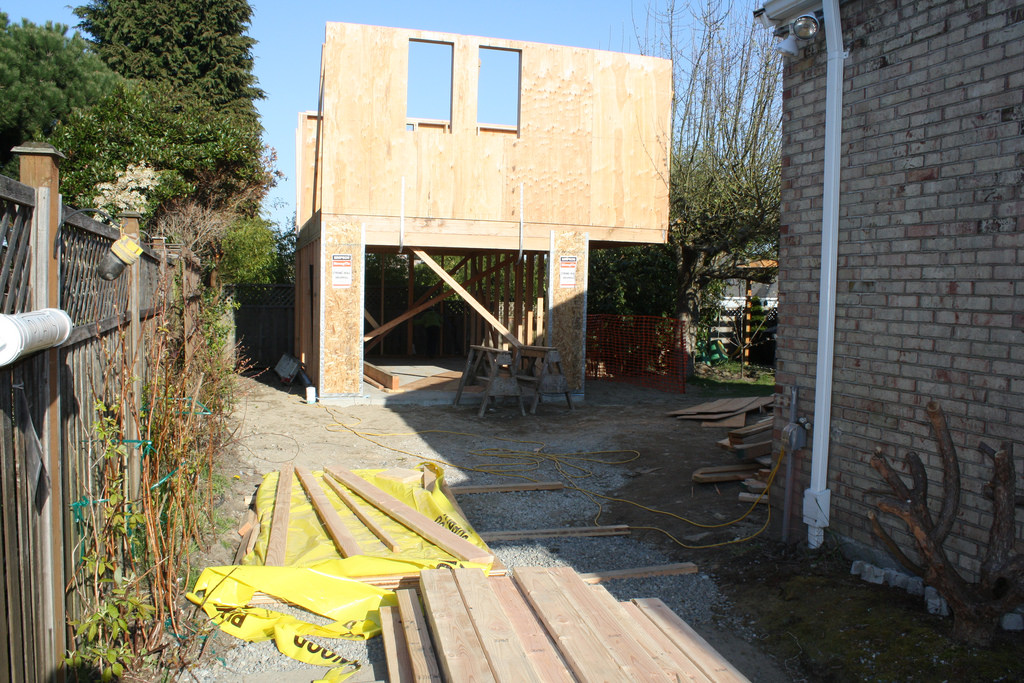 caption: Jim Loter documented building a backyard cottage in Seattle. Here's a picture from day 25: erecting the walls.
