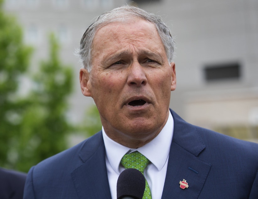 caption: Gov. Jay Inslee, shown here at the Federal Detention Center in SeaTac in June, has traveled on behalf of the Democratic Governors Association more than a dozen times in 2018. 