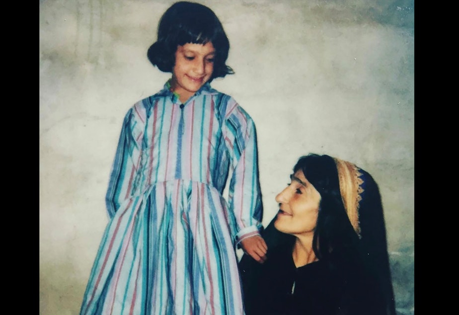 caption: Zarby Kakar with her mother, Addie, who stayed up all night sewing a new dress for her before coming to the United States. "I was so proud to wear that dress," said Kakar. 