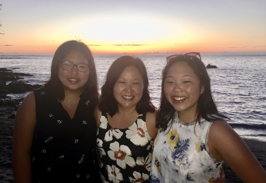 caption: Terri Chung, center, and her daughters Ella and Caitlin in Hawaii 2019.