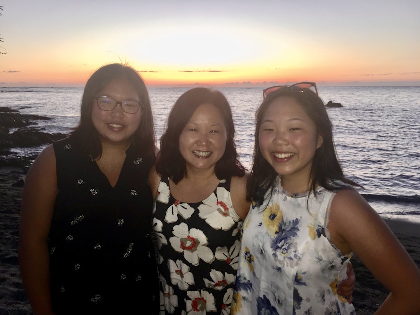 caption: Terri Chung, center, and her daughters Ella and Caitlin in Hawaii 2019.