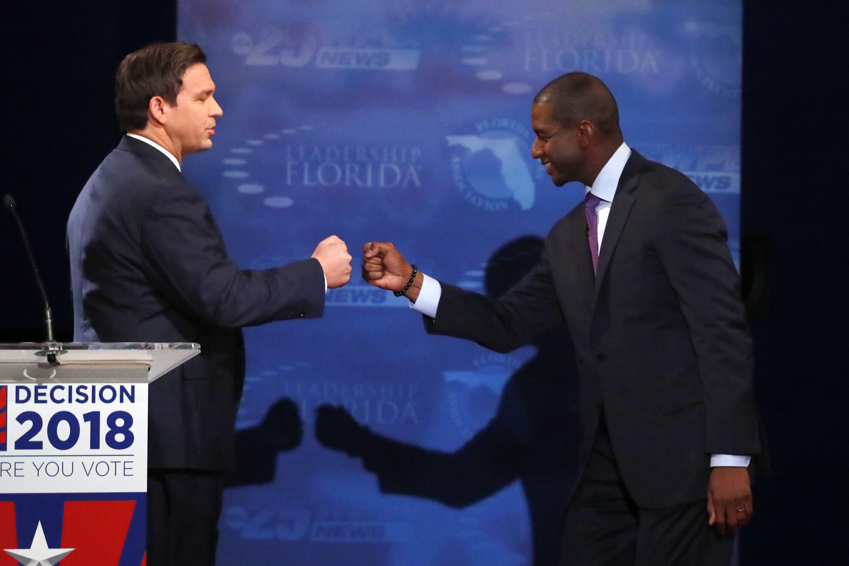 caption: In this Oct. 24, 2018, photo, Florida gubernatorial candidates, Republican Ron DeSantis, left, and Democrat Andrew Gillum fist bump after a debate at Broward College in Davie, Fla. The final stretch of the midterm campaign is increasingly dominated by debate over one of the most sensitive issues in American political culture: Race. In Florida, accusations of racism are playing a central role in the hotly-contested campaign for governor. DeSantis chafed at questions about his ties to supporters who have made