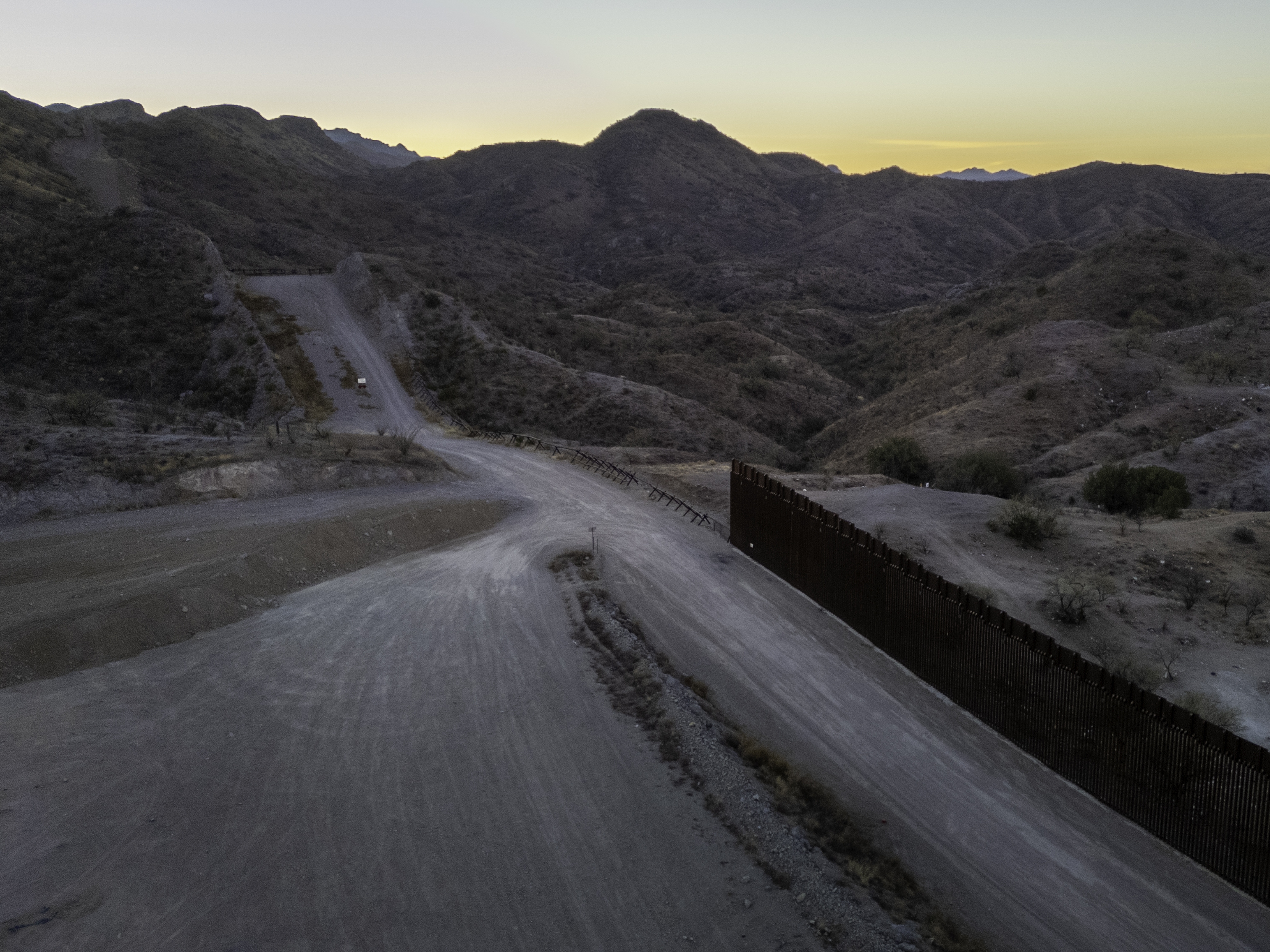 caption: From an aerial view, the U.S.-Mexico border fence ends with a gap on Jan. 20, 2025 near Sasabe, Ariz. Republicans' tax and spending bill includes $46.5 billion for border wall projects.