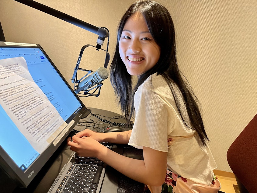 caption: Evelyn Jiang records their narration for their RadioActive story in a KUOW studio on July 14, 2022.
