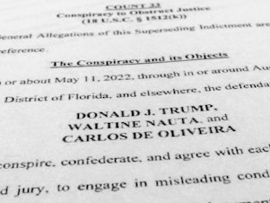 caption: Former President Donald Trump, aide Nauta and Mar-a-Lago property manager Carlos de Oliveira face some 40 criminal counts over classified documents found at Trump's Florida residence and club.