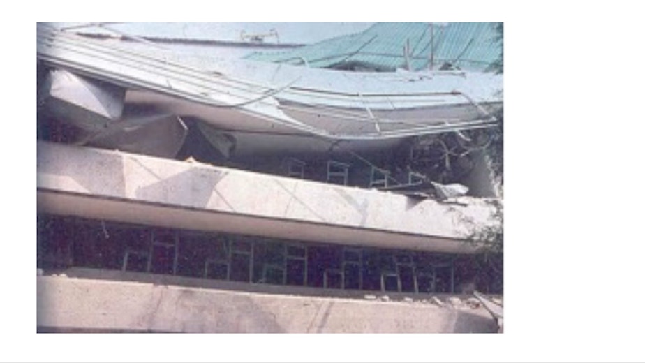 caption: Desks hold up the roof of a building in Mexico in 1985 following an earthquake. 
