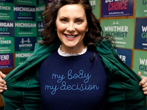 caption: Michigan State Governor Gretchen Whitmer shows a "My Body My Decision" shirt at the 14th District Democratic Headquarters in Detroit, Michigan, on November 8, 2022.