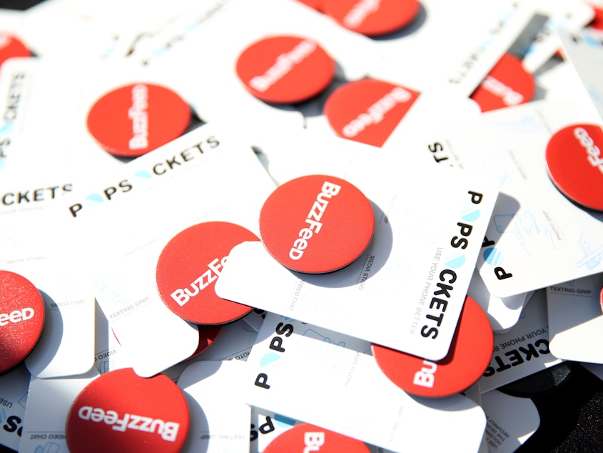 caption: BuzzFeed swag, heaped on a table at a July 2017 party hosted by the online publication and The CW in San Diego. BuzzFeed's CEO, Jonah Peretti, announced Wednesday that the company expects to cut 15 percent of its employees.