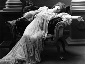 caption: Stage actress Sarah Bernhardt (1844-1923) reclines in a scene from an unnamed theater production.