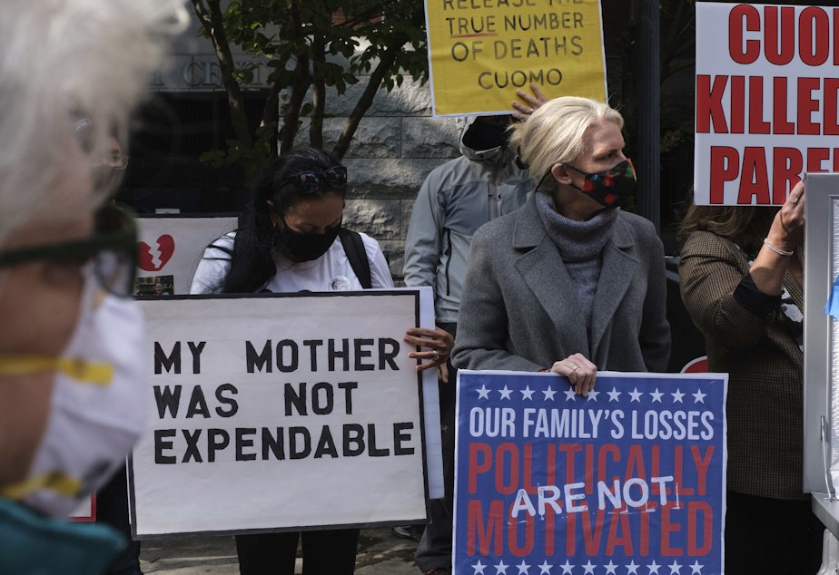 caption: Families of COVID-19 victims who died in New York nursing homes gather in front of the Cobble Hill Heath Center in the Brooklyn borough of New York City in October. A report issued Thursday by New York's state attorney general says health officials undercounted nursing home deaths by as much as 50%.