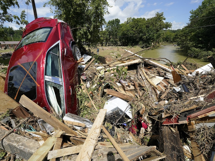 caption: Debris could be seen piled up in Waverly, Tenn., on Sunday after heavy weekend rains caused deadly flash flooding. Climate change is driving more torrential rain around the world.
