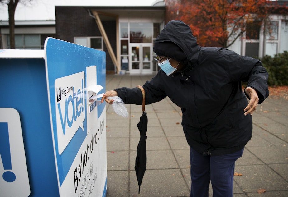 caption: King County voter Paulette drops of her ballot on Tuesday, November 3, 2020, at the Garfield Community Center drop box along East Cherry Street in Seattle.