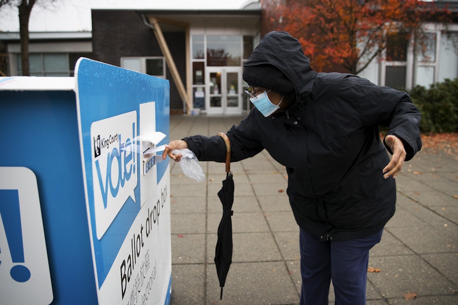 caption: King County voter Paulette drops of her ballot on Tuesday, November 3, 2020, at the Garfield Community Center drop box along East Cherry Street in Seattle.