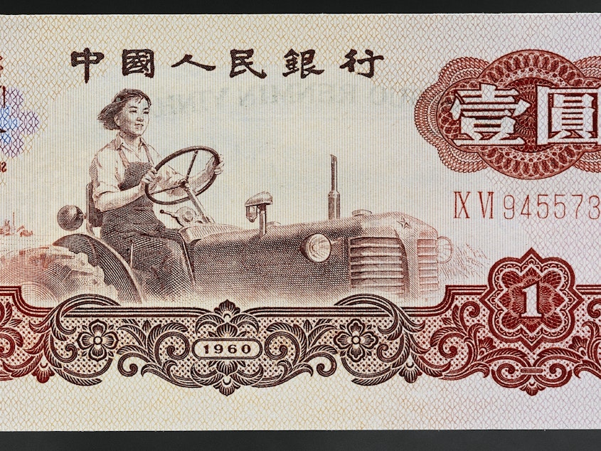 caption: Liang Jun, a tractor driver and Soviet model worker, was immortalized in the 1960s on China's 1 yuan banknote.