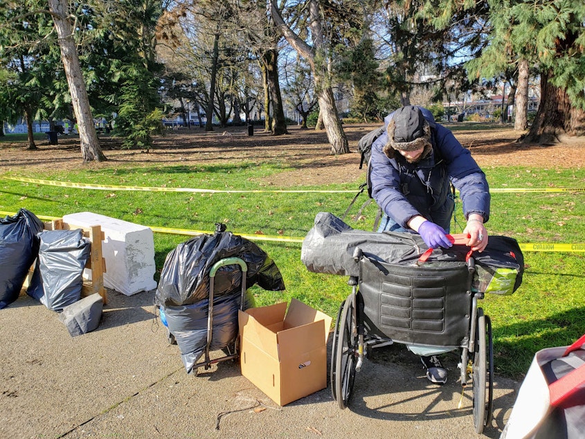 caption: Campers like Dewitt were not directed to housing services as Seattle Police cleared Denny Park on Wednesday, March 3, 2021.