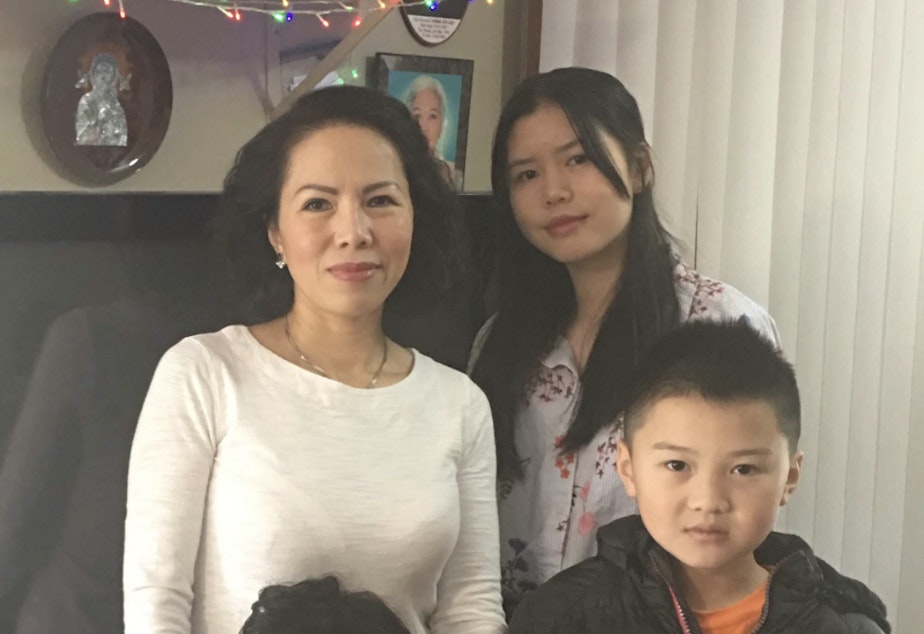 caption: RadioActive's Jennifer Nguyen (top right) poses with her mom, Michell, and her siblings.