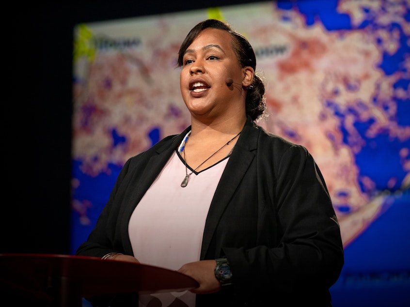 caption: Colette Pichon Battle speaks from the TED stage.