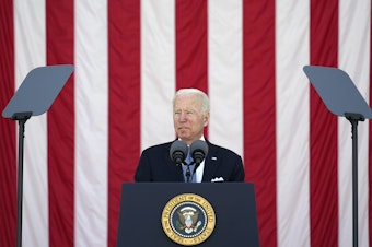 caption: President Joe Biden speaks during the National Memorial Day Observance at Arlington National Cemetery Monday. His budget proposal drops a decades-long ban on public funding for abortion.