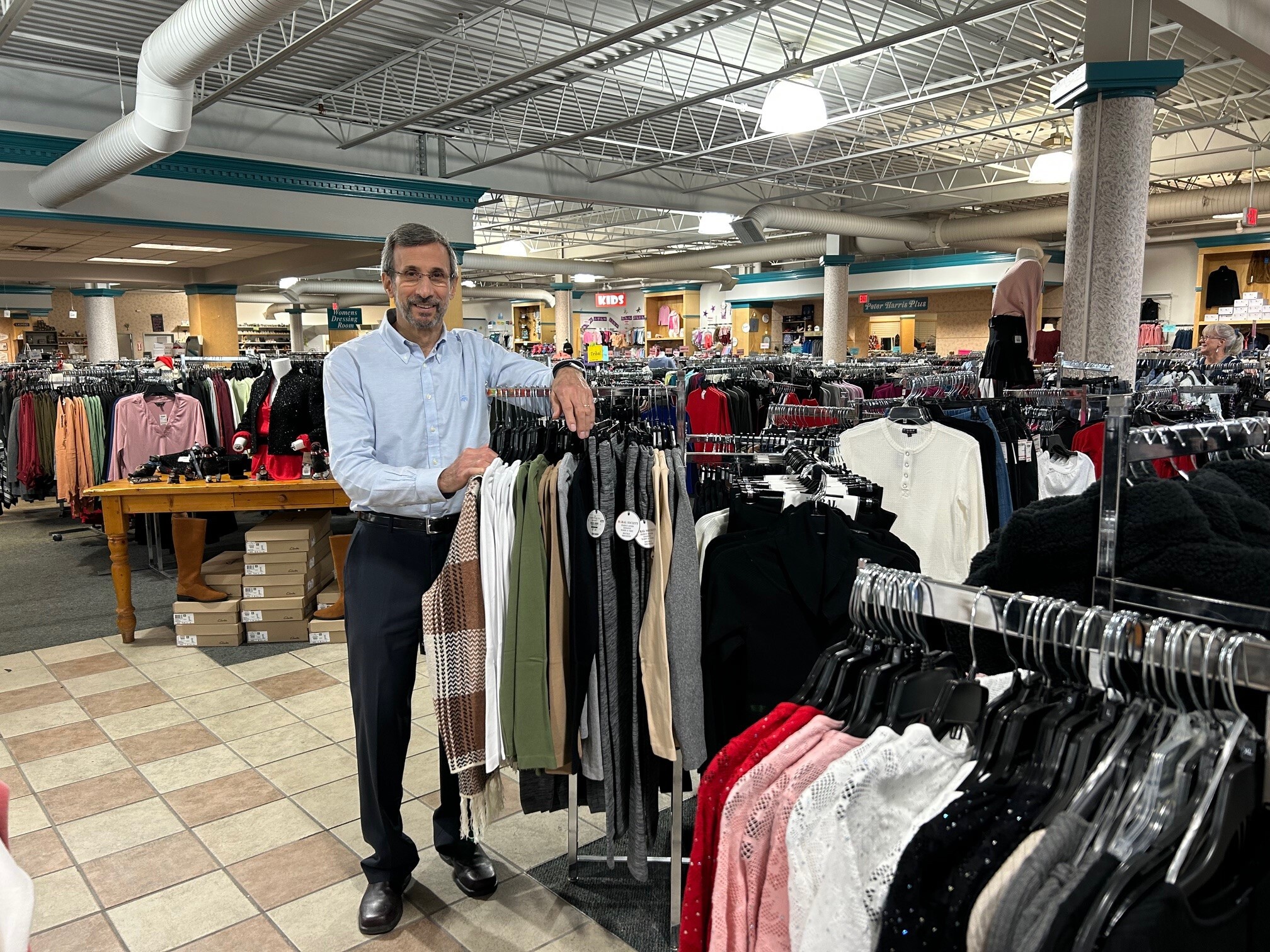 caption: Peter Elitzer, who runs a chain of discount clothing stores called Label Shopper, worries that tariffs will force him to raise prices, turning off already skittish shoppers.
