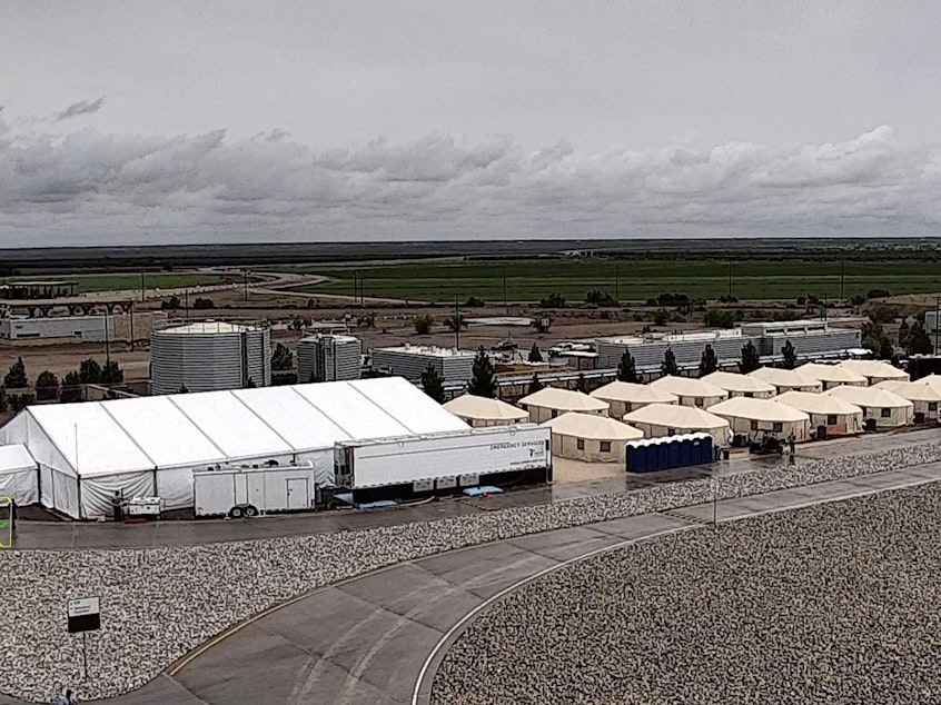 caption: A West Texas tent shelter for unaccompanied minor immigrants in Tornillo, Texas. The government announced this week that the camp is expanding from 1,200 to 3,800 beds to accomodate an increasing number of immigrants crossing the border.